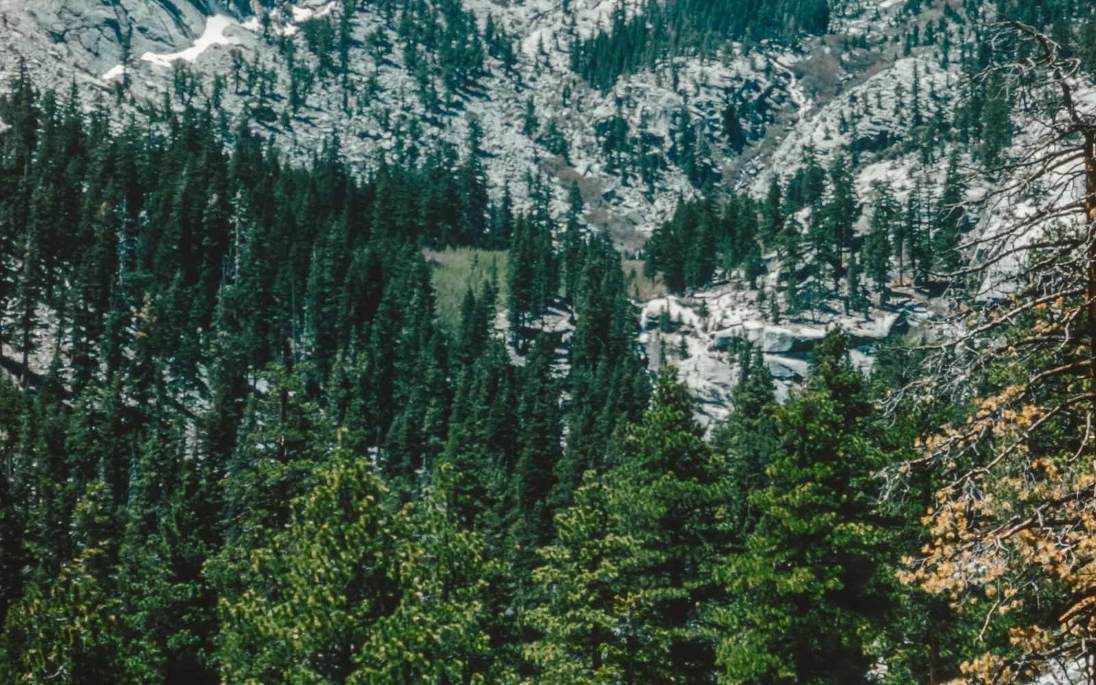 Mountain landscape with snow-capped peaks and valley vista